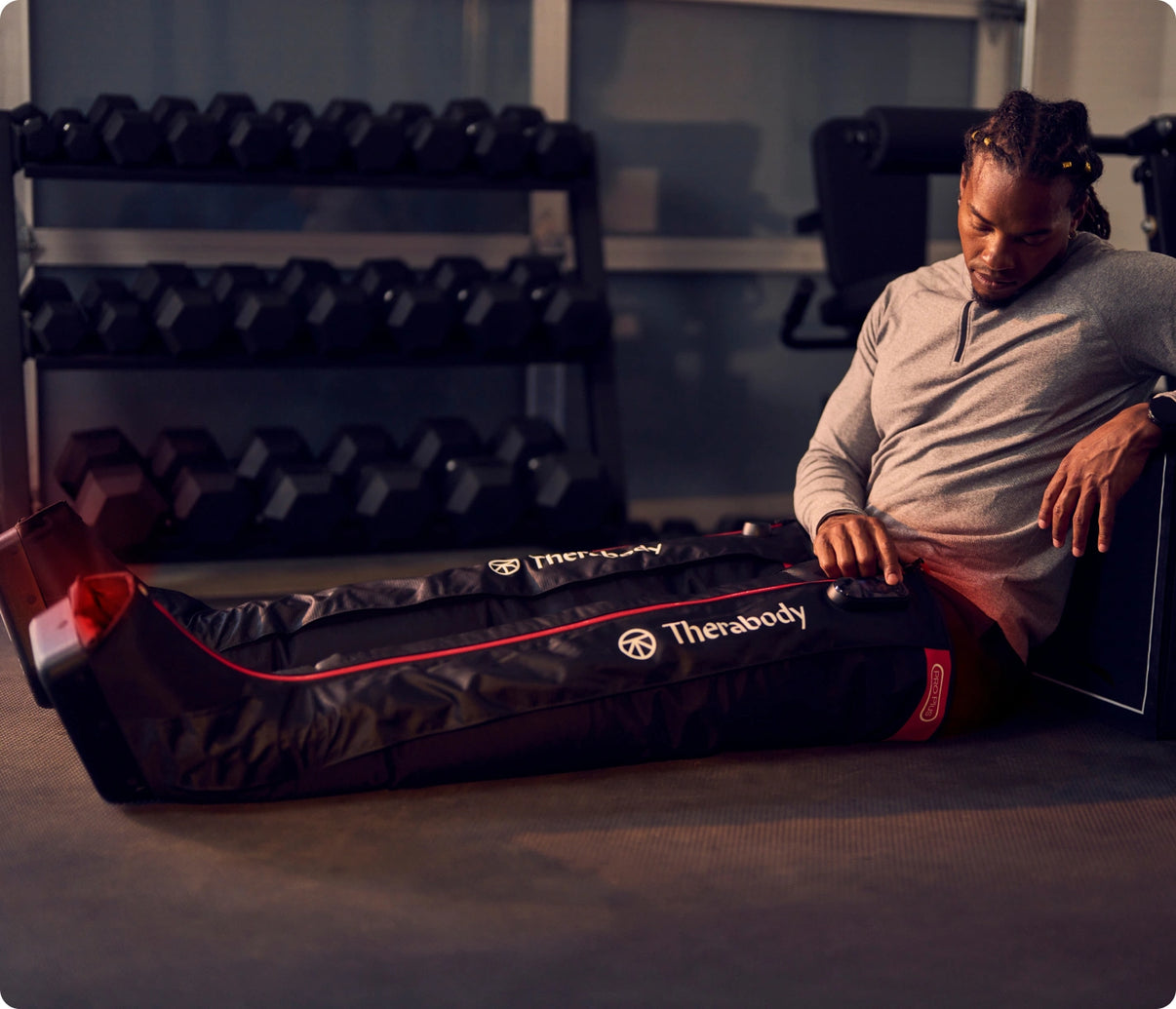 Man using Jetboots pro plus on the floor for recovery
